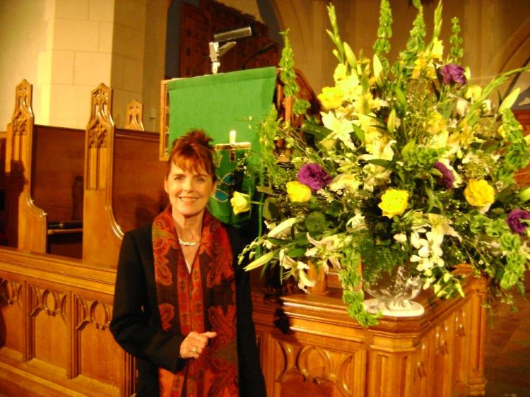 Photograph of Linda Vogt Turner holding a bouquet of flowers at St. Andrew’s Wesley United Church in 2009, symbolizing resurrection and hope.